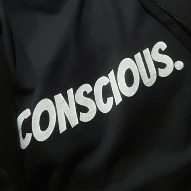 Conscious. Gender Neutral Tee as worn by Happy, in a Medium size.